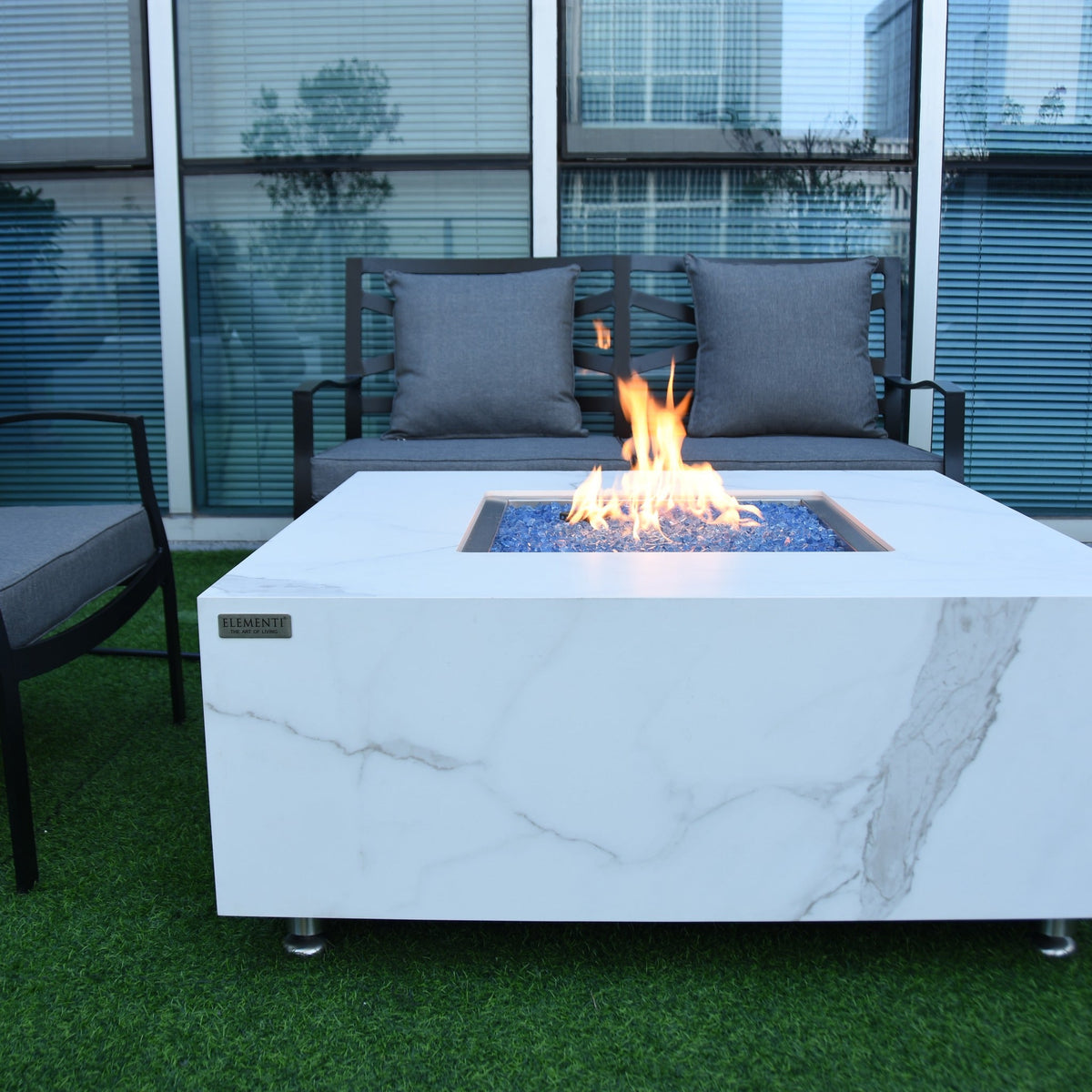 Elementi Plus Bianco Fire Table - Modern Outdoor Terrace Setting with Burning Fire and Lounge Furniture