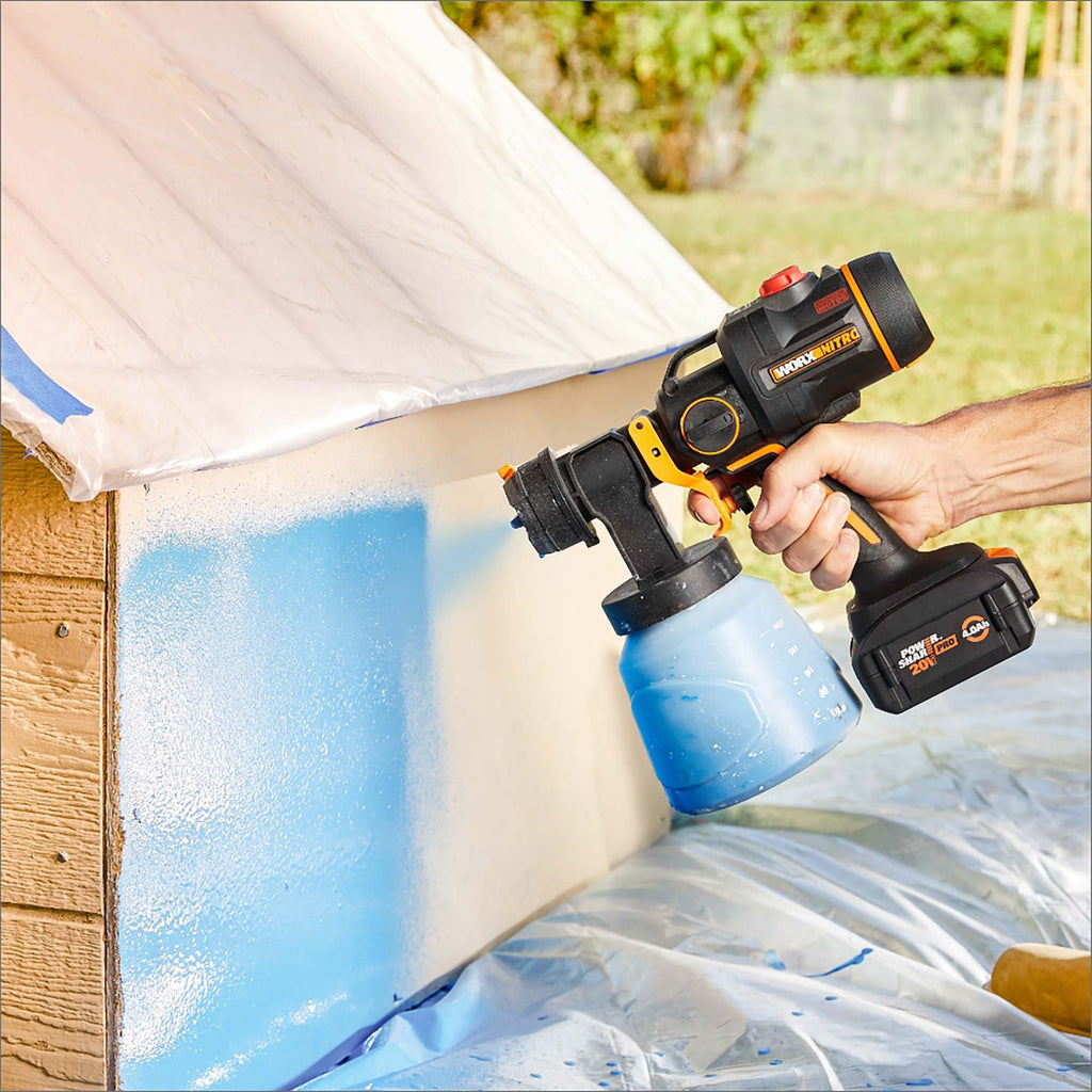 Spraying a wooden fence with the Worx Nitro cordless paint sprayer